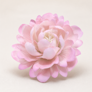Pink peony ceramic flower with layered petals on a clean warm studio background